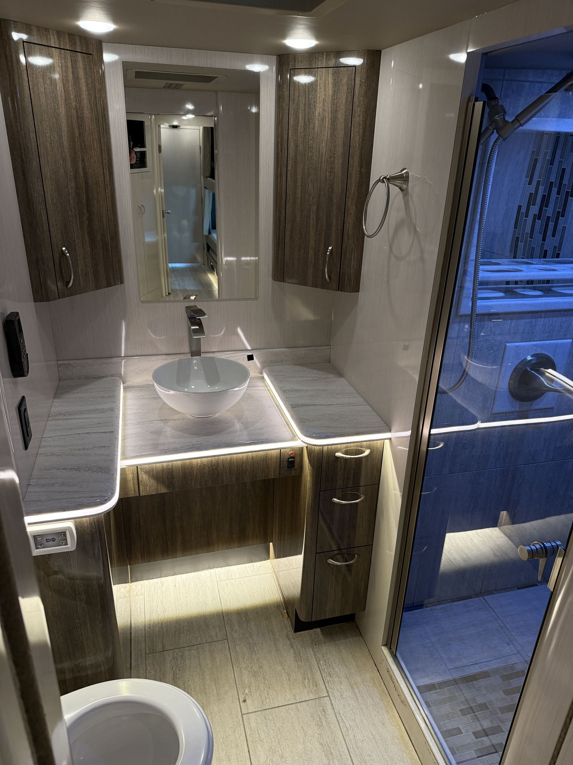 interior lounge of luxury coach featuring leather seating and ambient lighting