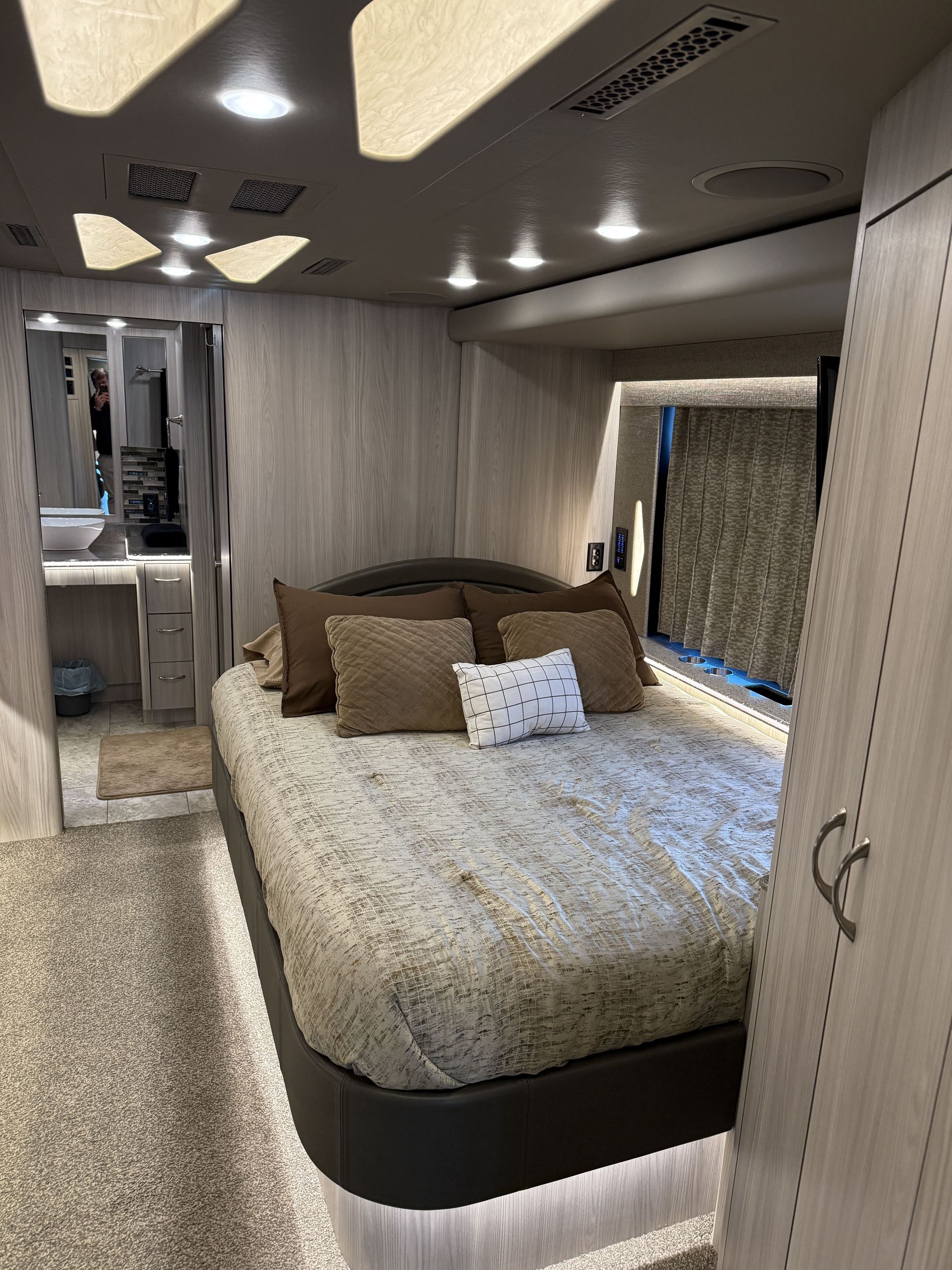 interior lounge of luxury coach featuring leather seating and ambient lighting