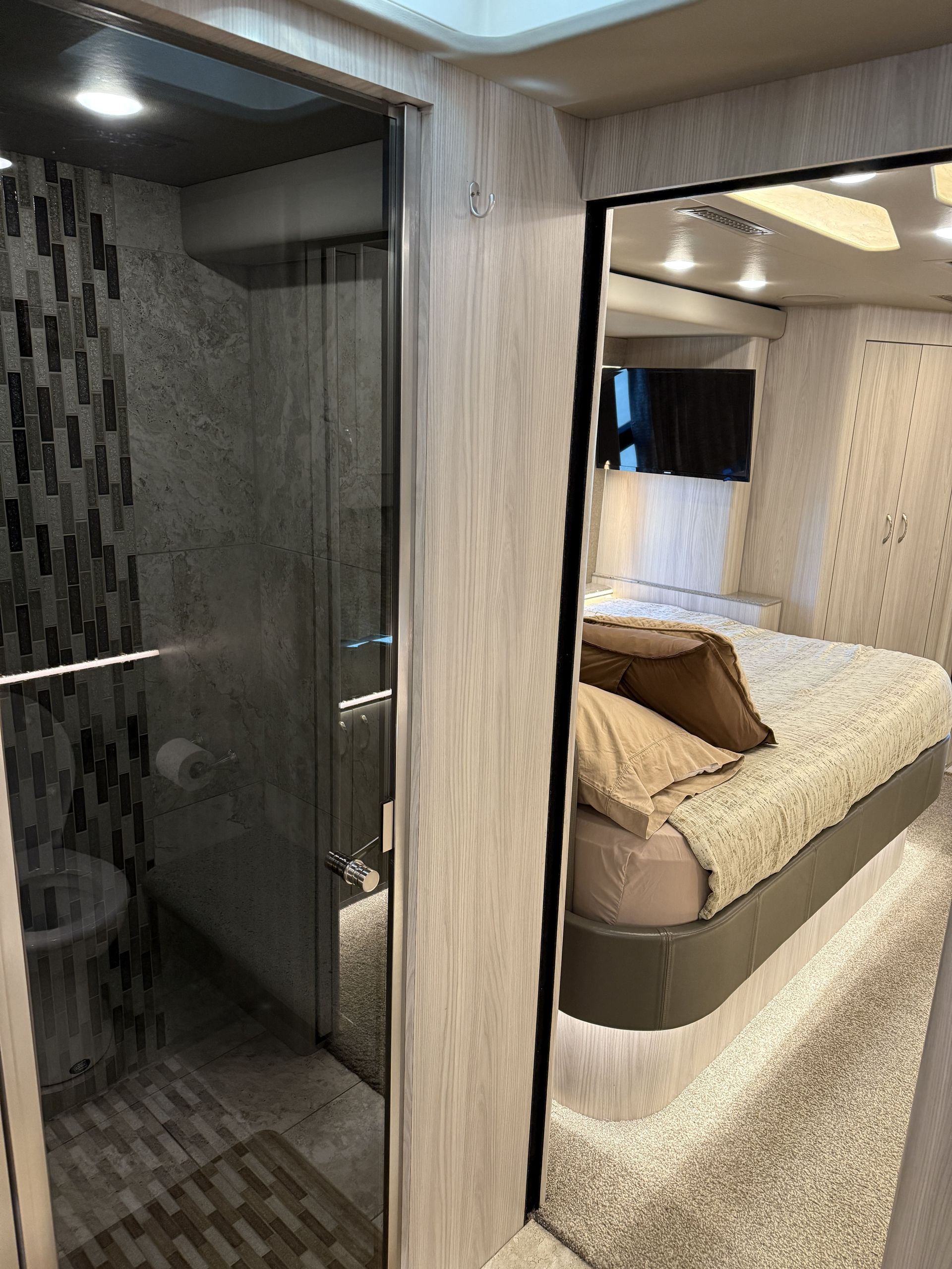 Luxury entertainer coach parked with slide-out extended for maximum space