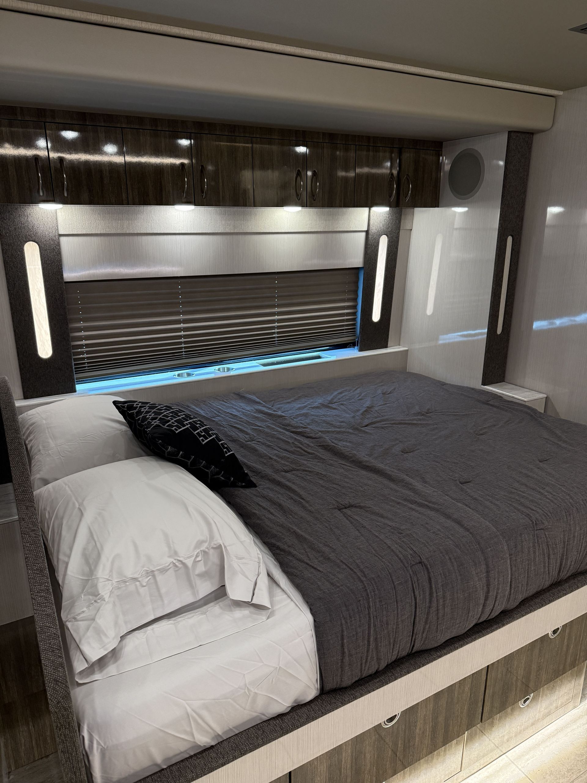 interior lounge of luxury coach featuring leather seating and ambient lighting