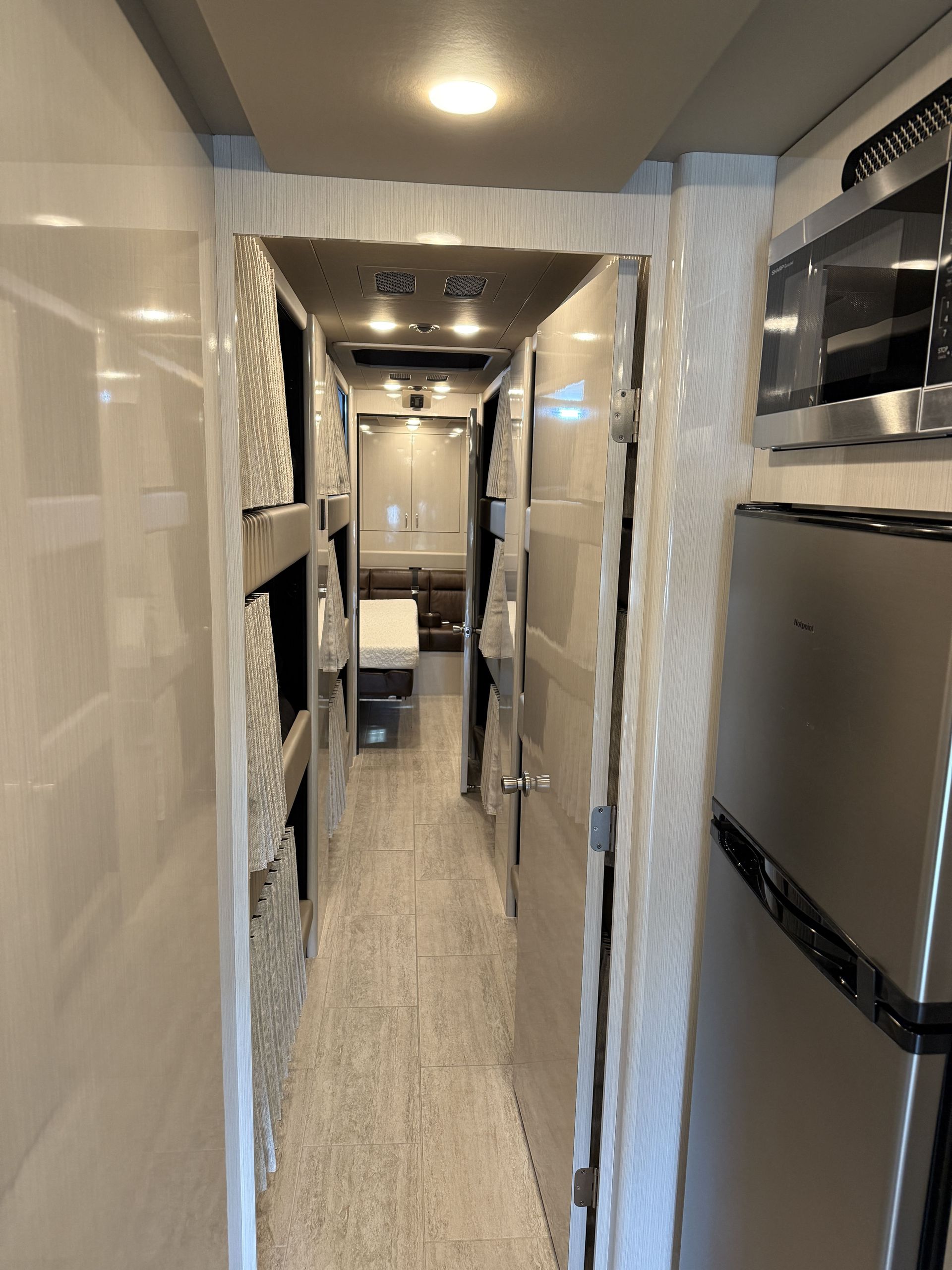 interior lounge of luxury coach featuring leather seating and ambient lighting