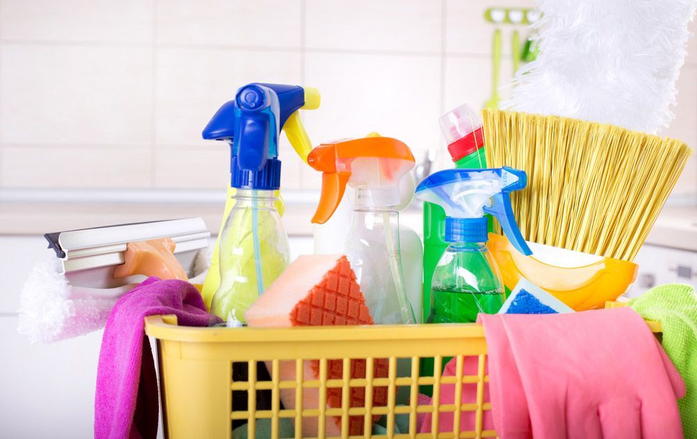 Basket With Cleaning Items Beside Kitchen Stoves — Jamac Cleaning Services in Valentine, NSW