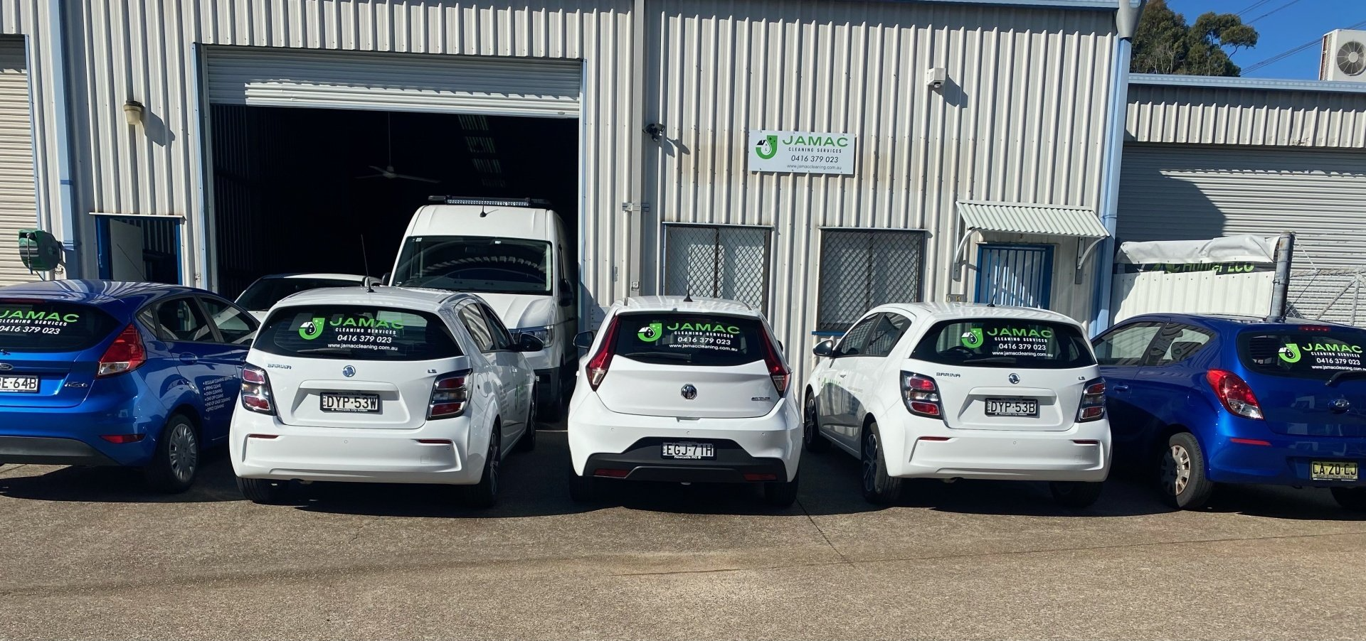 Group of White Cars in Front of Warehouse - Cleaning Services in Cardiff, NSW