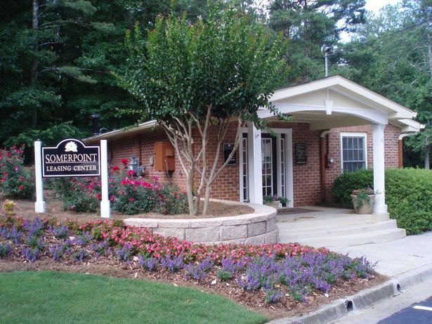 A photo of a long, multi-story apartment building with stairs leading up to it
