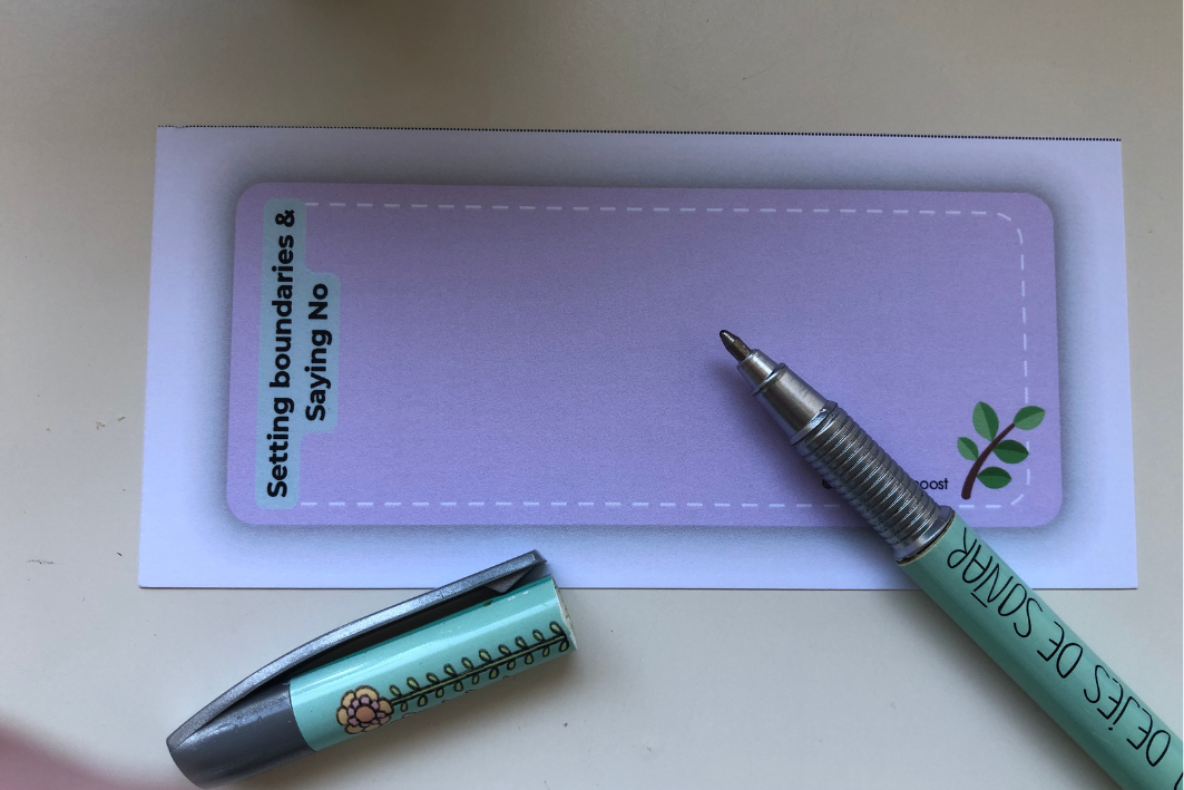 A pen is sitting on a empty coaching or selfreflection card that Says setting boundaries and saying no