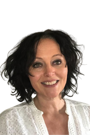 A woman with dark hair is wearing a white shirt and smiling.
