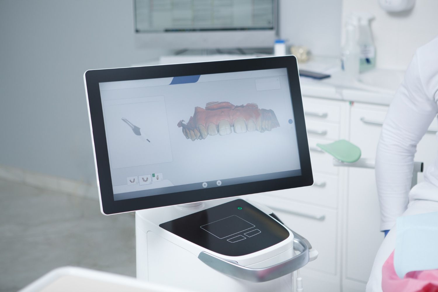 A computer monitor is sitting on a table in a dental office.