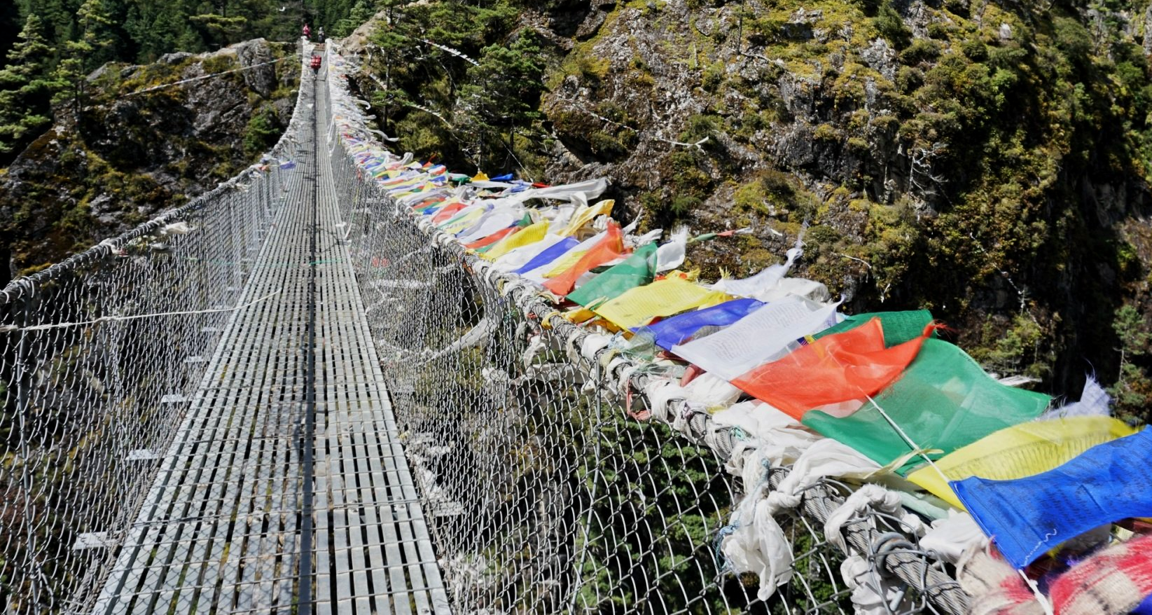 bridge over river gorge with prayer flags solukhumbu nepal