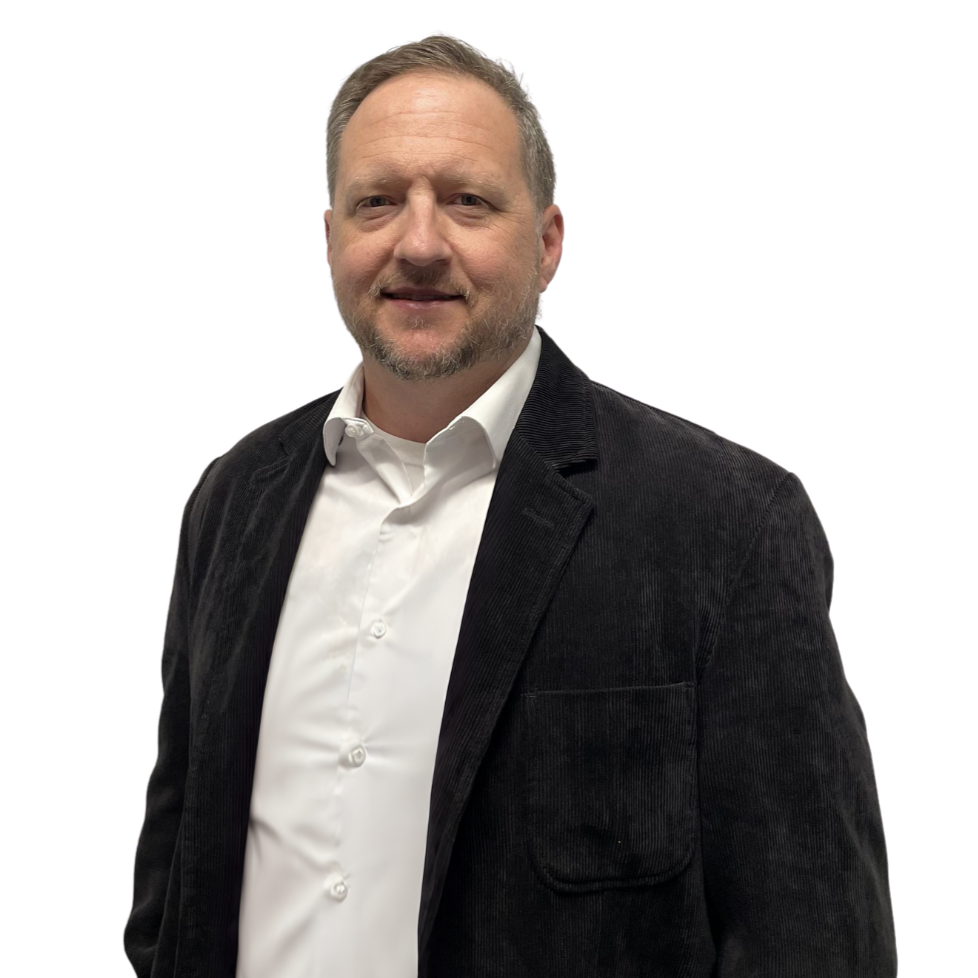 A man with a beard wearing a black jacket and white shirt
