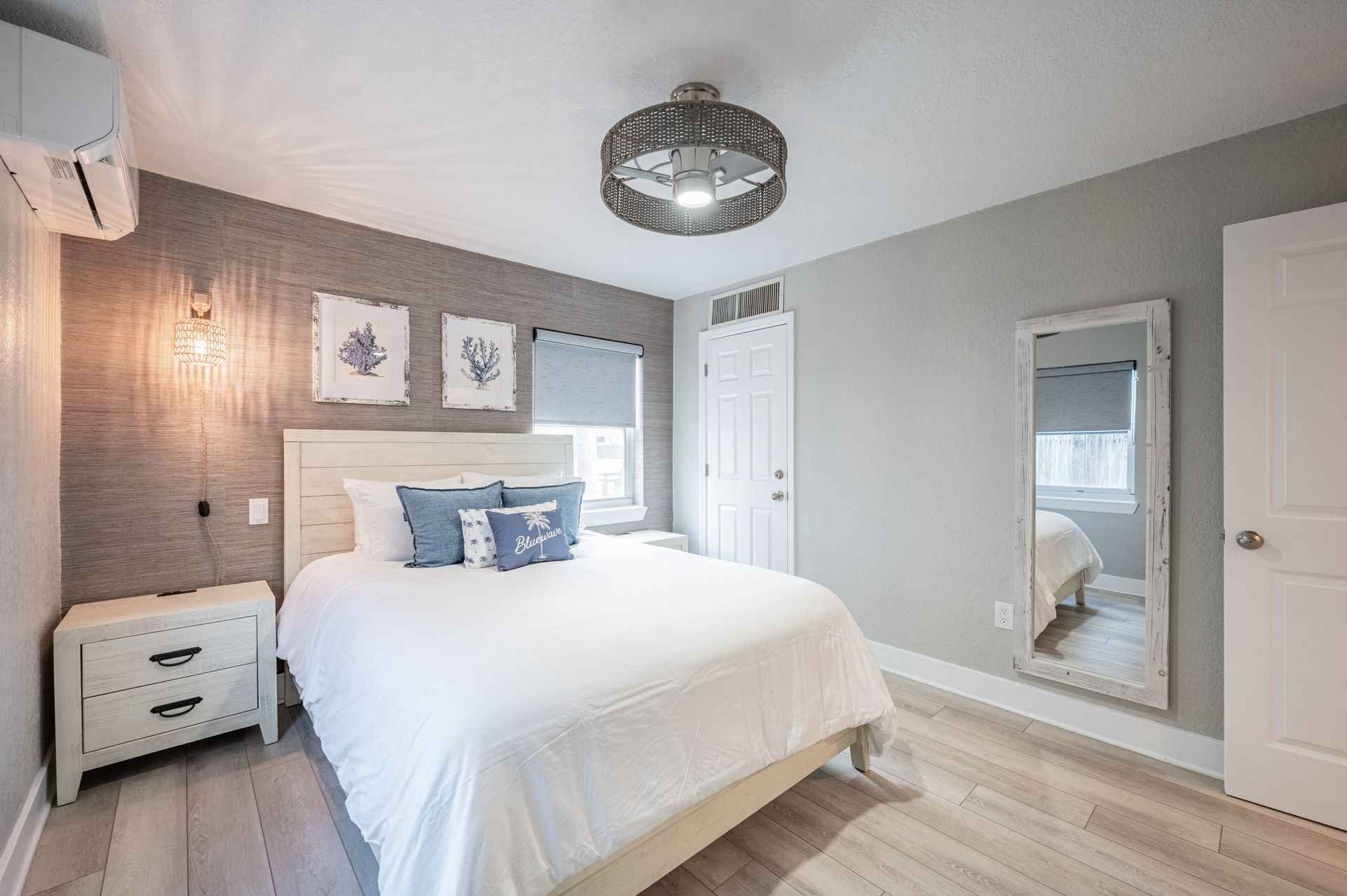 A bed with white sheets and pillows in a room with blue walls
