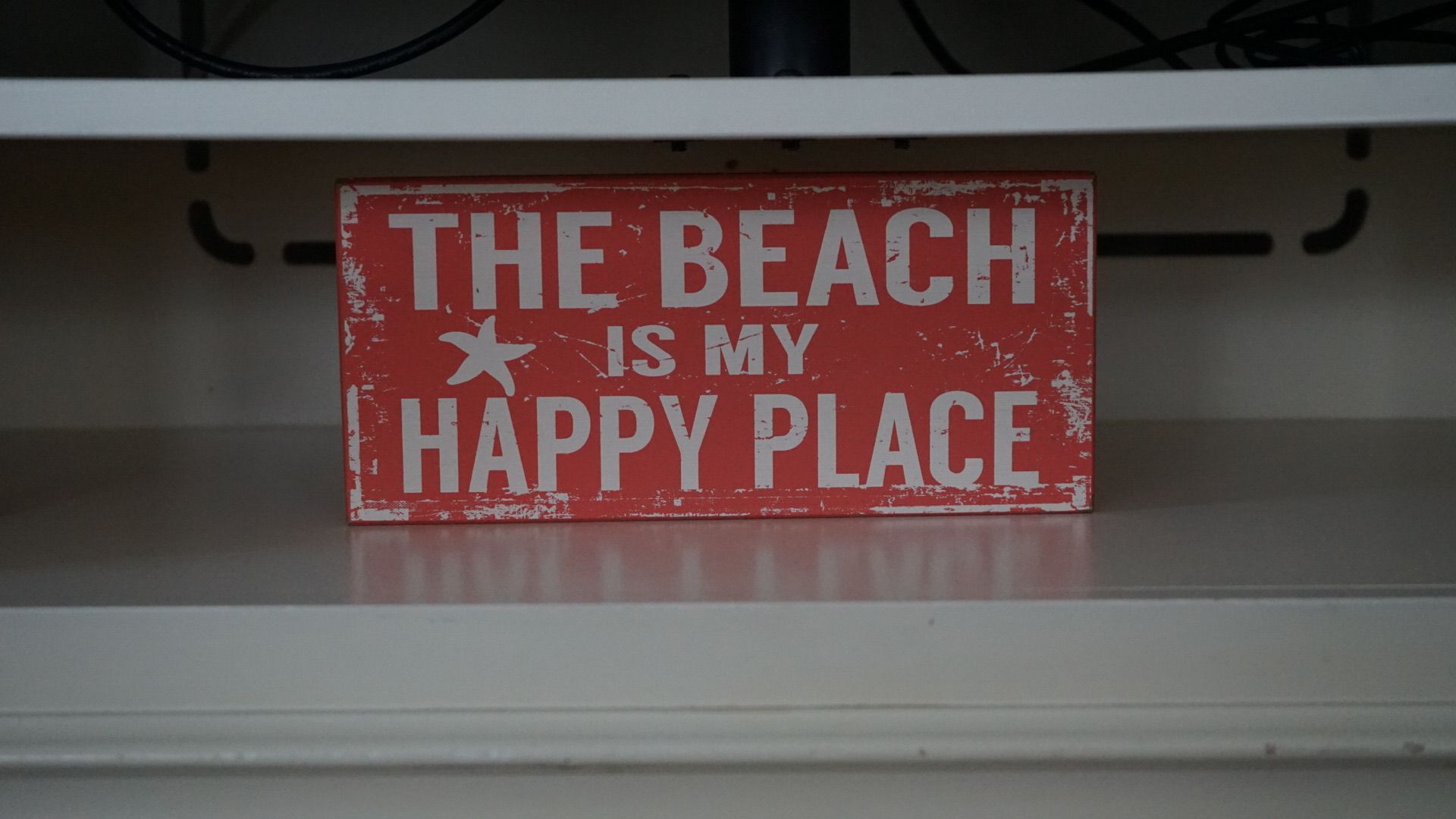 A sign that says the beach is my happy place