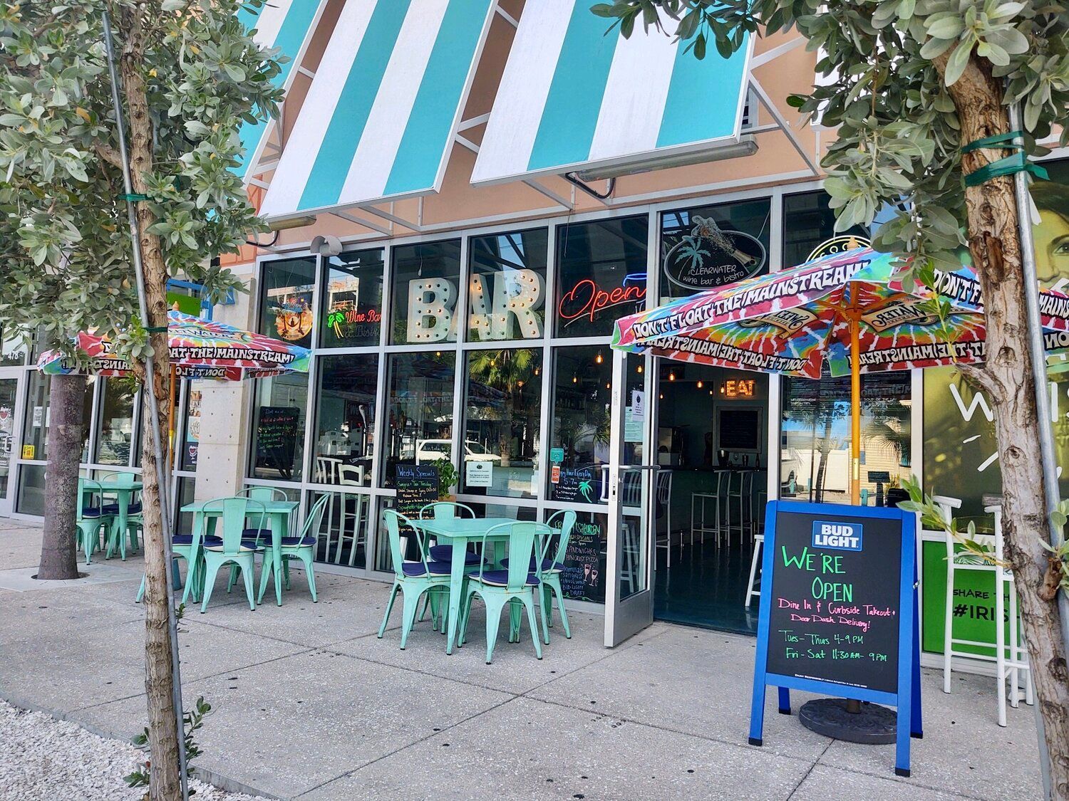 A restaurant with tables and chairs in front of it