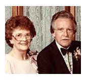 A man and a woman are posing for a picture together.