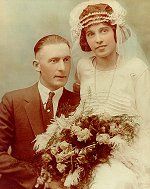 A bride and groom are posing for a picture on their wedding day.
