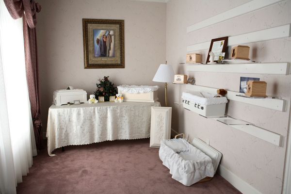 A room with a table and a picture on the wall