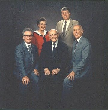 A group of men in suits and ties pose for a picture