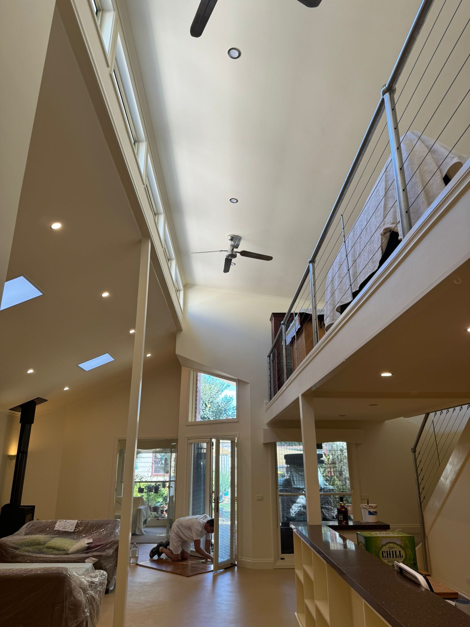 Open-plan living space with high ceilings and a mezzanine level — Andrew Harper Painting & Decorating in Albury, NSW