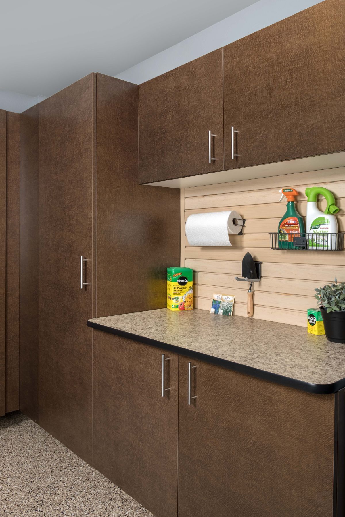 A kitchen with brown cabinets and a counter top.