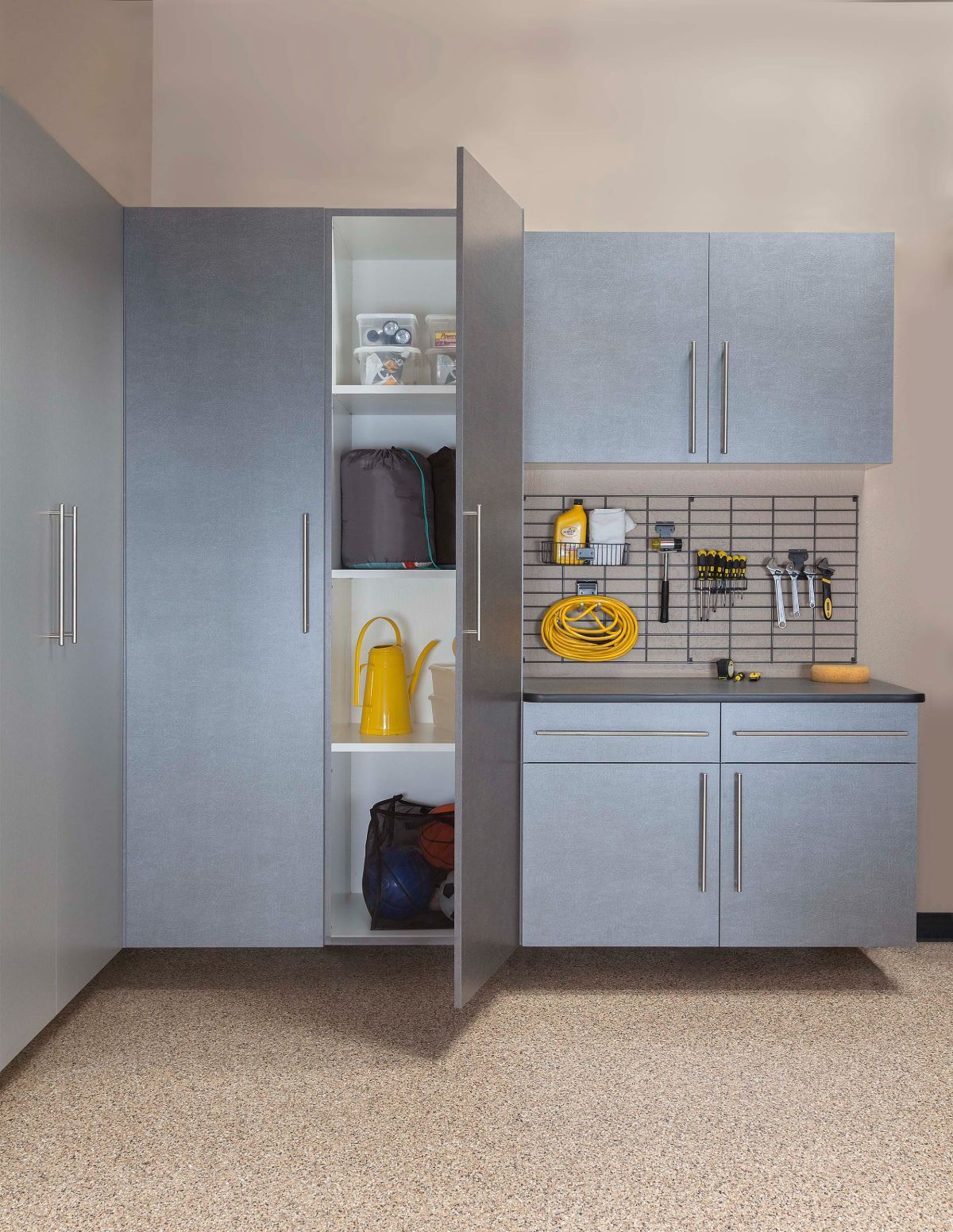 A garage with gray cabinets and a yellow watering can
