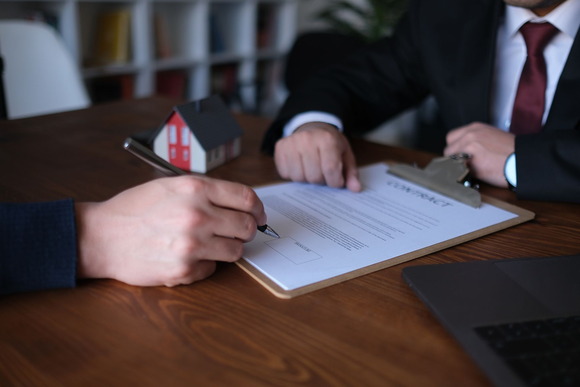 Mutual agreement and signing with a real estate lawyer and his client.