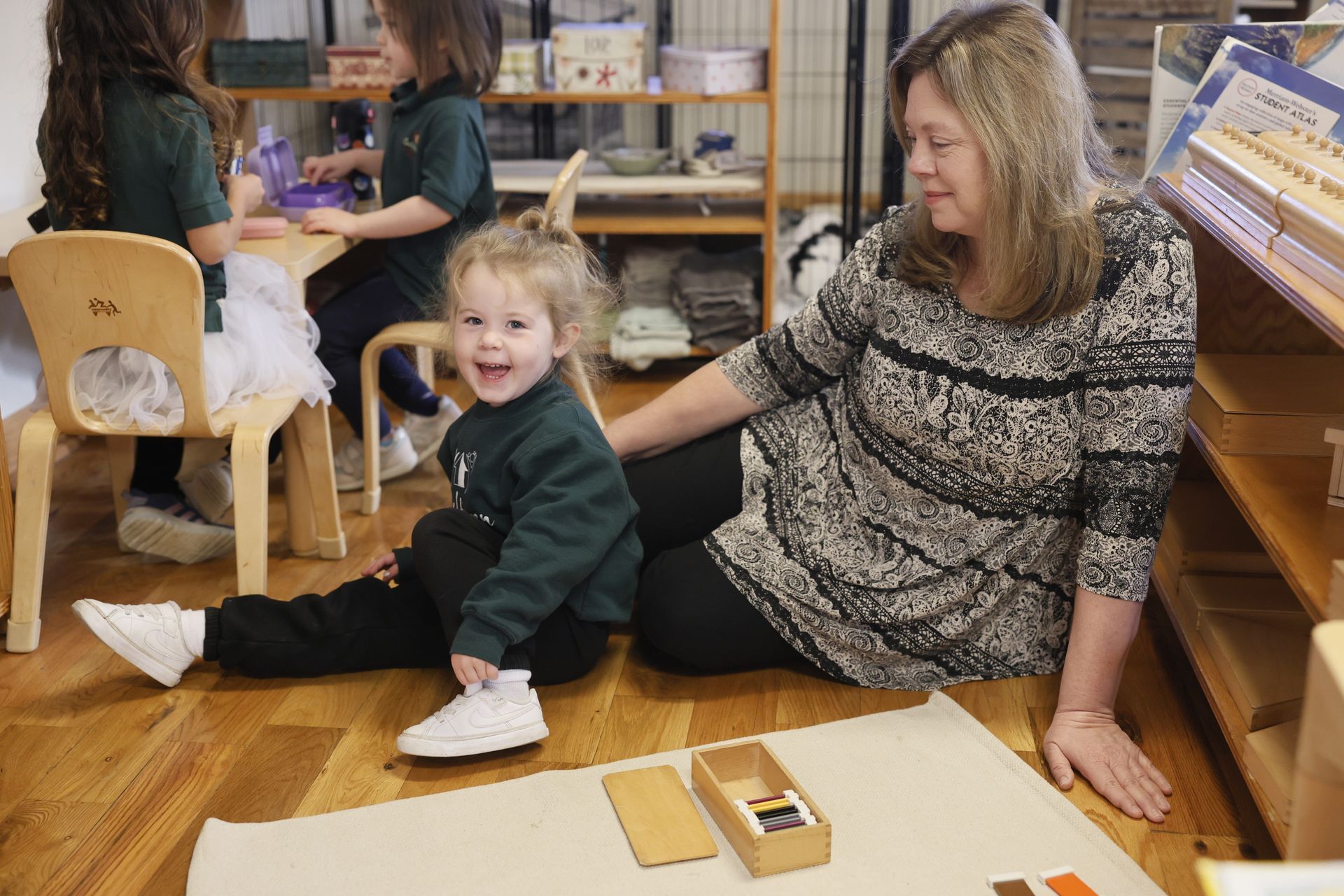 Montessori guide smiling at her student