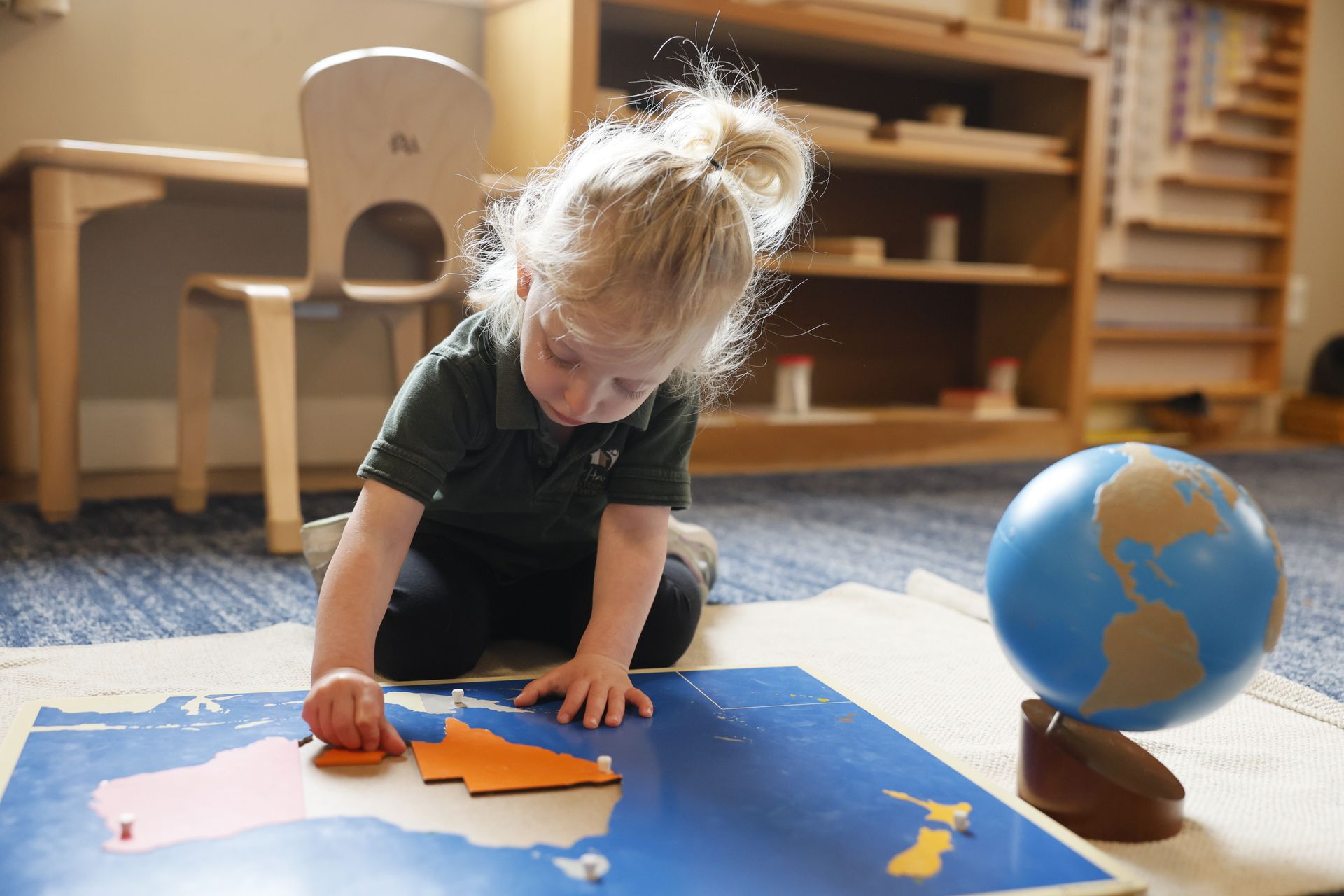 Montessori child working with geography materials