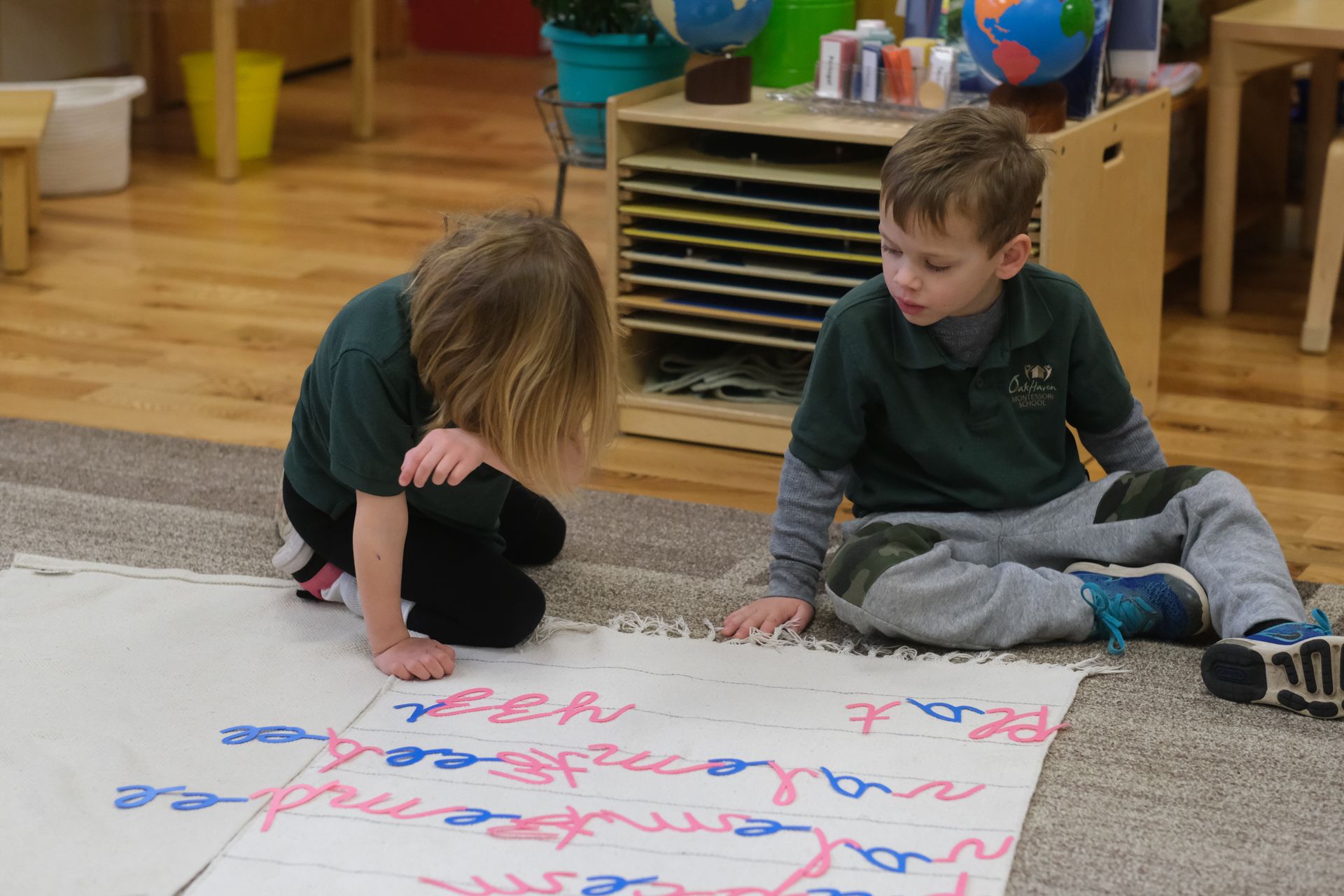 Montessori children working with language materials