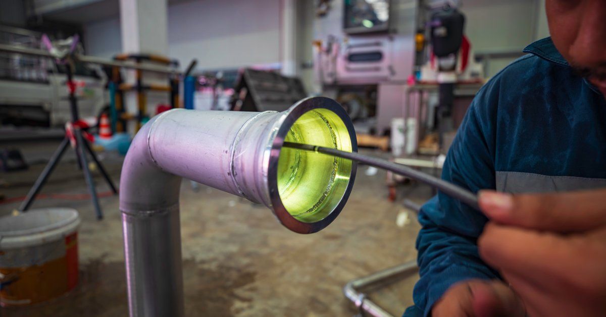 Someone pushing a snake camera through a pipe with an L-curve in in. You can see the light from the camera shining out of it.