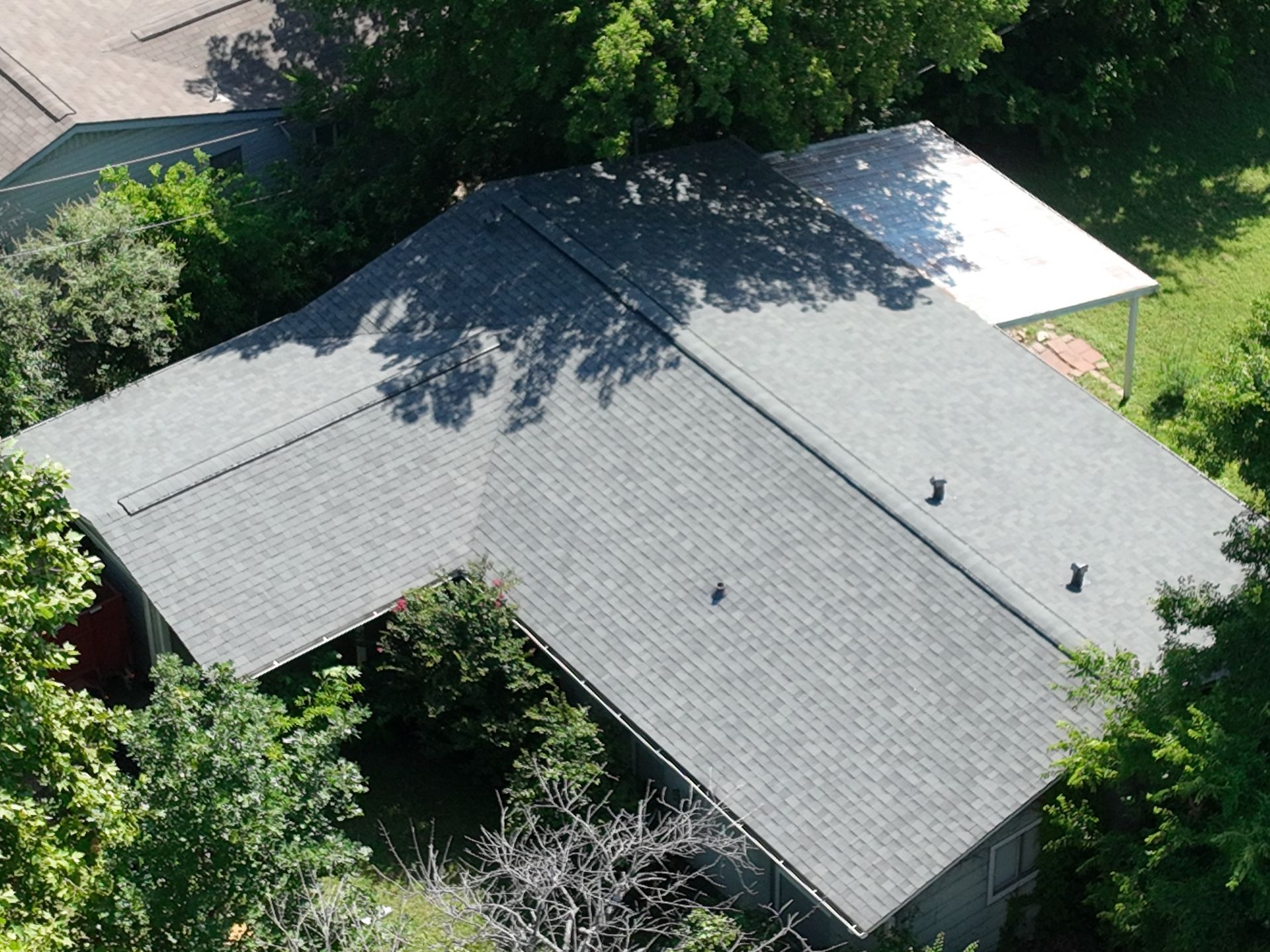 2,000 sqft Austin, TX, home with Owens Corning Duration shingles in Estate Gray, roof replacement due to hail damage and severe leaking, completed in one day.
