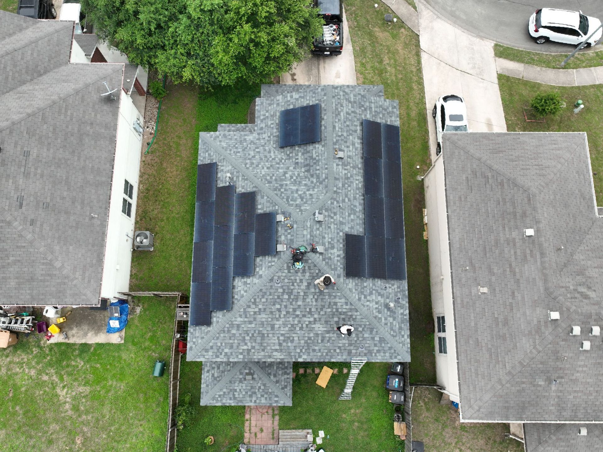 2-story, 2,600 sqft Austin home with Owens Corning Duration shingles in Estate Gray, roof replacement with solar panels after hail damage, insurance claim approved.