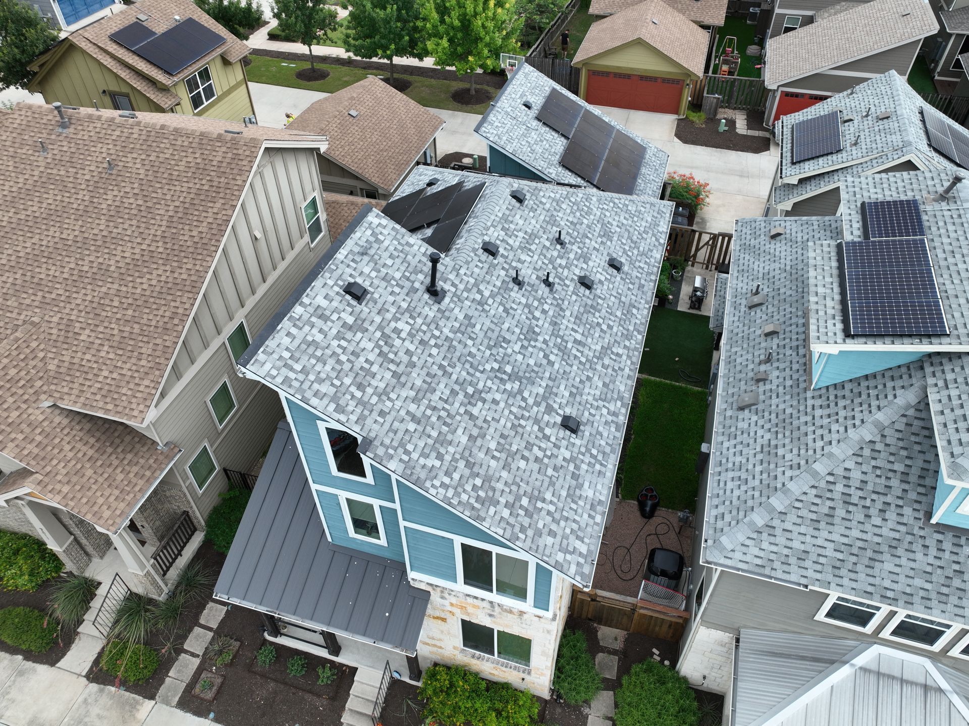 Hail damaged this 2,900 sqft Austin home’s roof. Risner Roofing secured full insurance coverage and replaced it with durable Owens Corning Duration shingles in Sierra Gray.