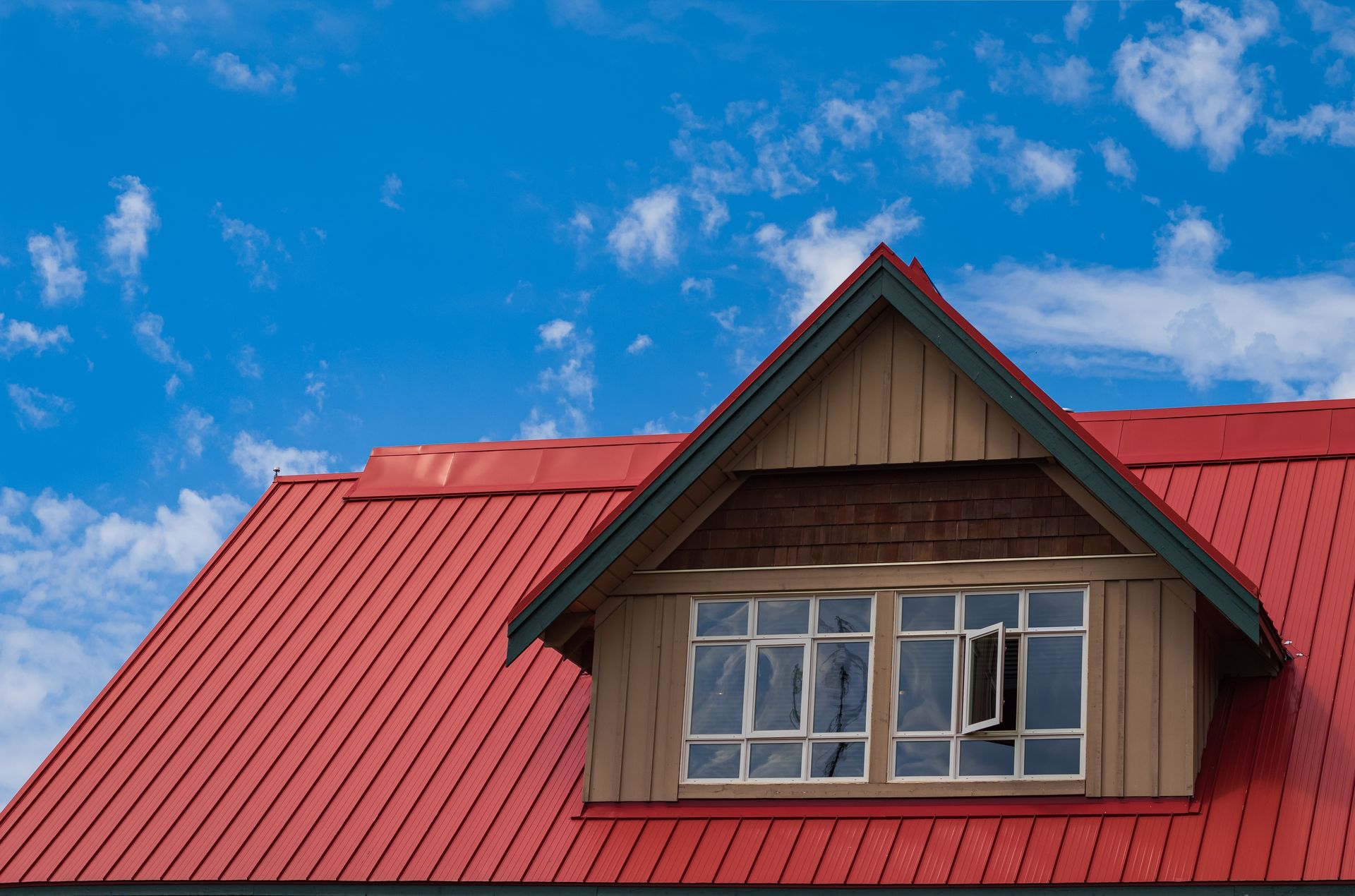 A house with a red roof and a window