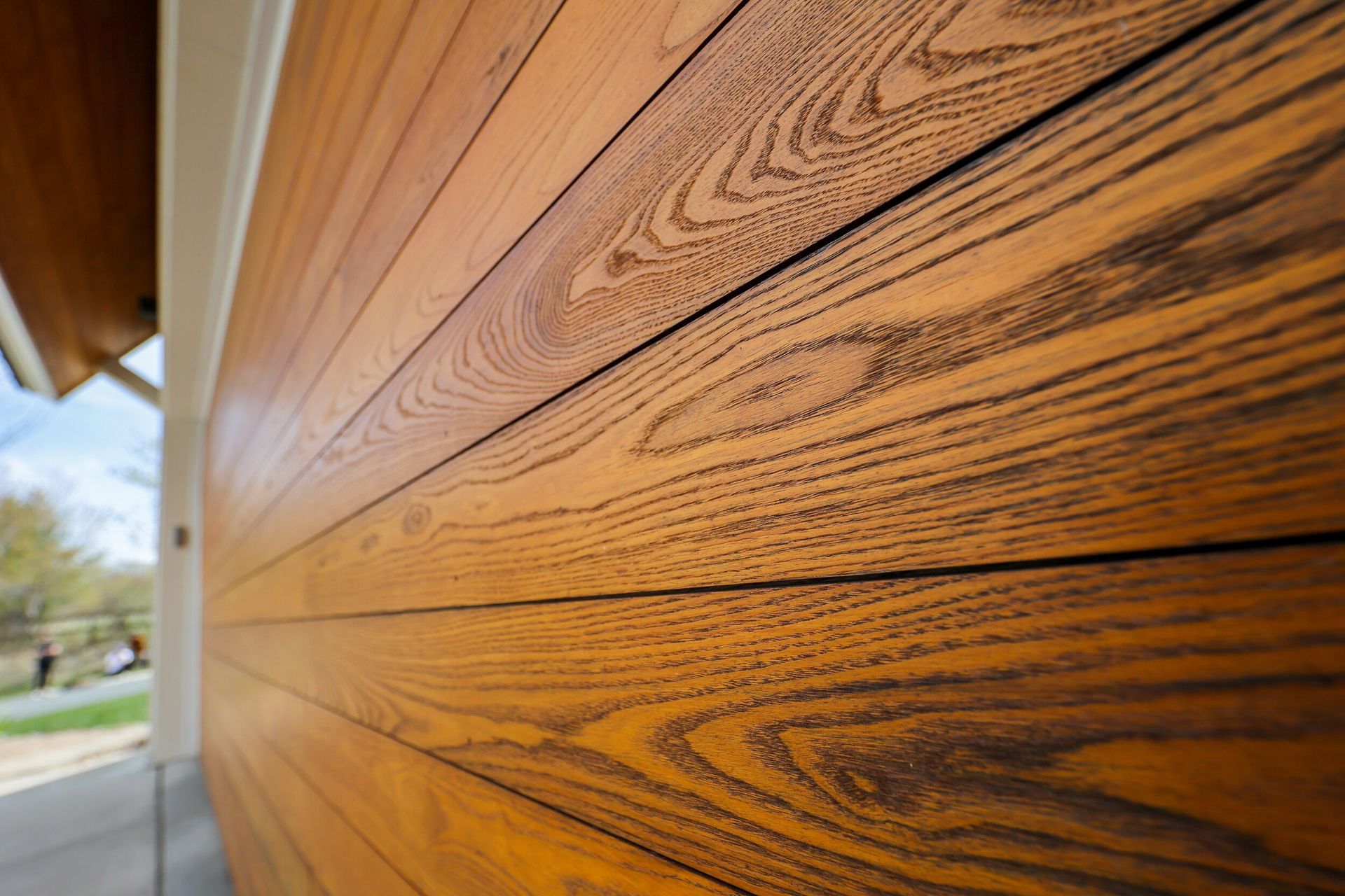 A close up of a wooden garage door on a house.