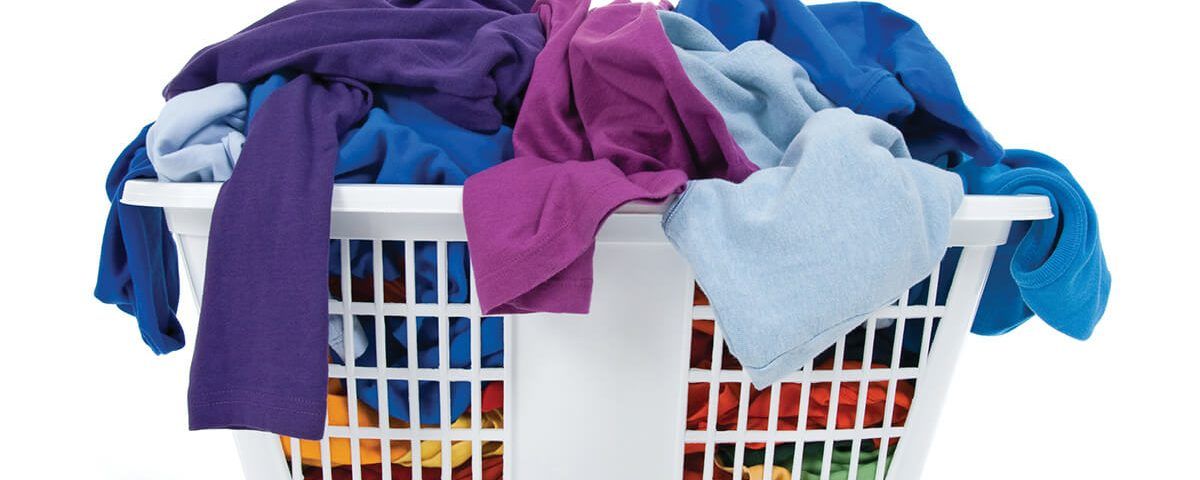 A laundry basket filled with clothes of different colors