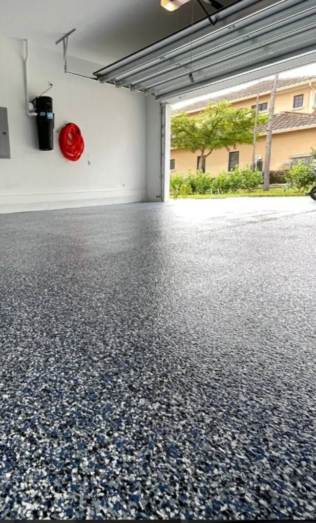 A garage with a car parked in it and a garage door open.