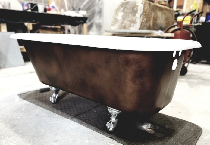 A bathtub with claw feet and a white top