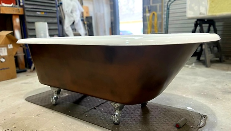 A bathtub is sitting on the floor in a room.