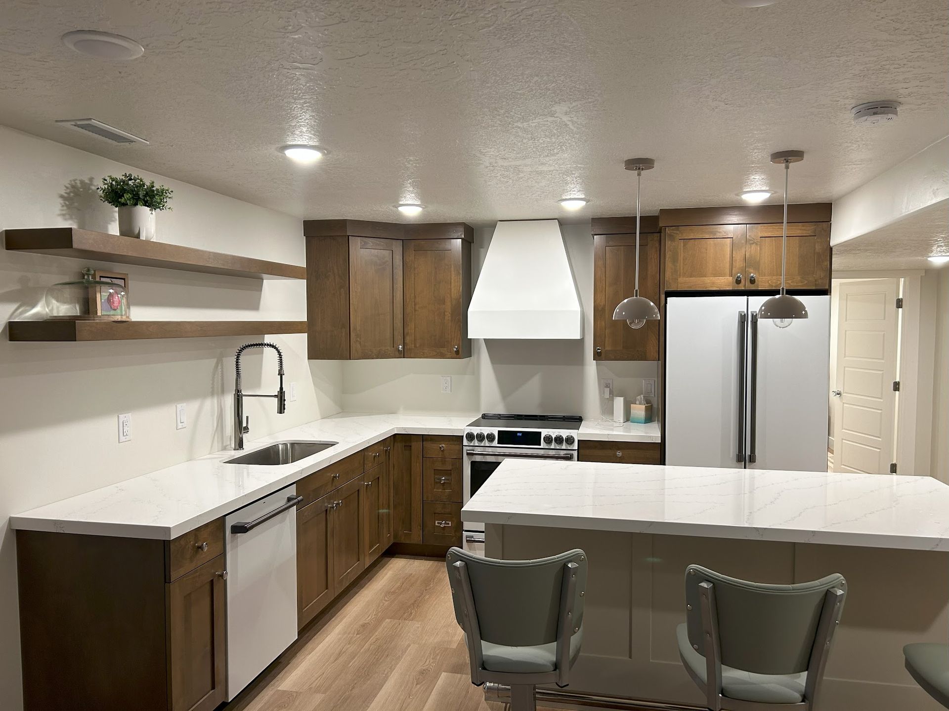A kitchen with wooden cabinets and white counter tops