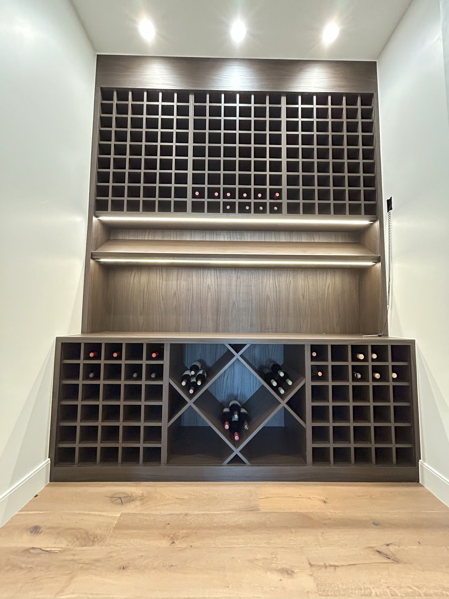 A wine cellar with lots of shelves and bottles on them