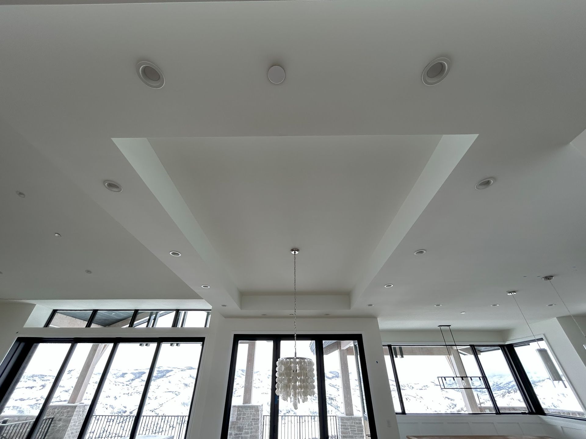 Looking up at the ceiling of a room with lots of windows