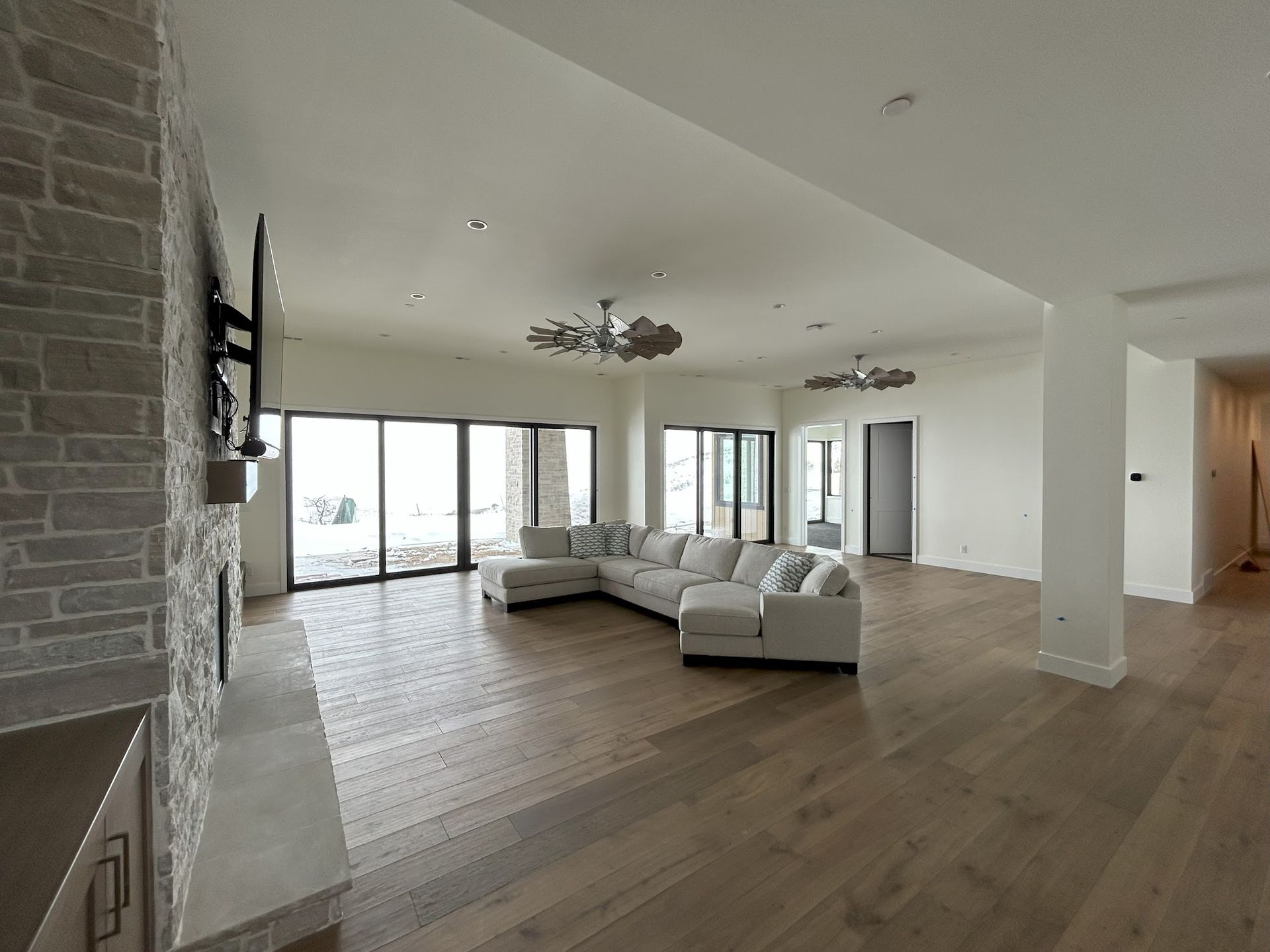 A large living room with a couch and a fireplace
