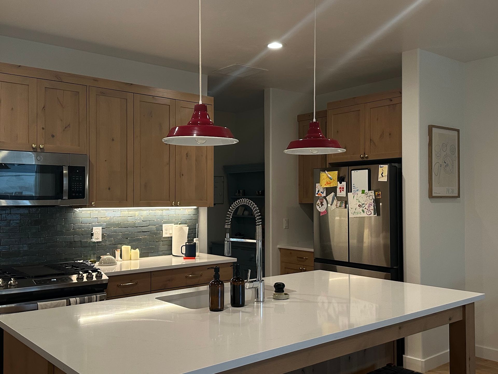A kitchen with stainless steel appliances and wooden cabinets