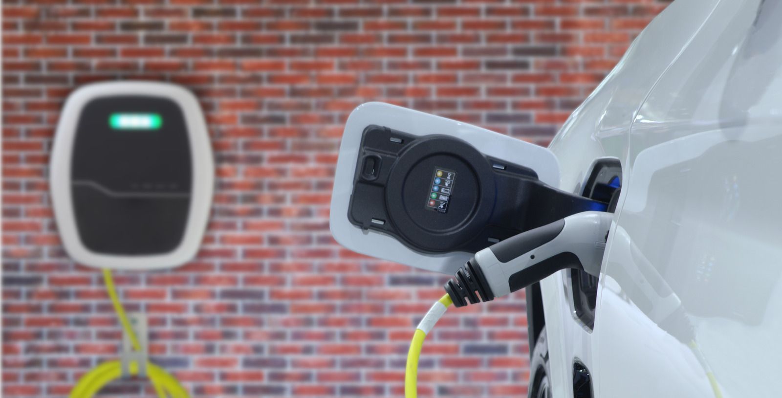 An electric car is being charged at a charging station.