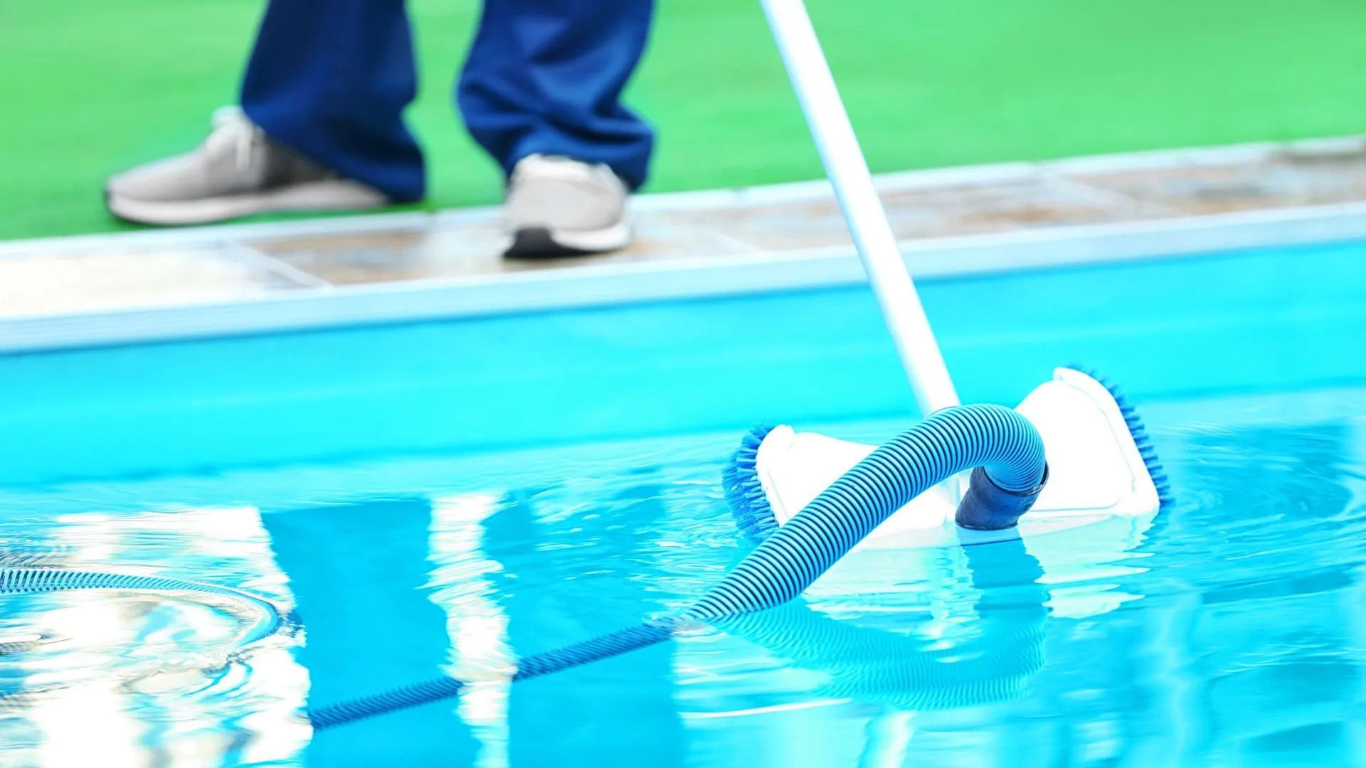 A person is cleaning a swimming pool.