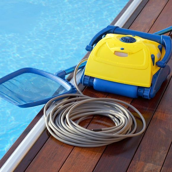 A yellow and blue swimming pool cleaner with a hose attached to it.