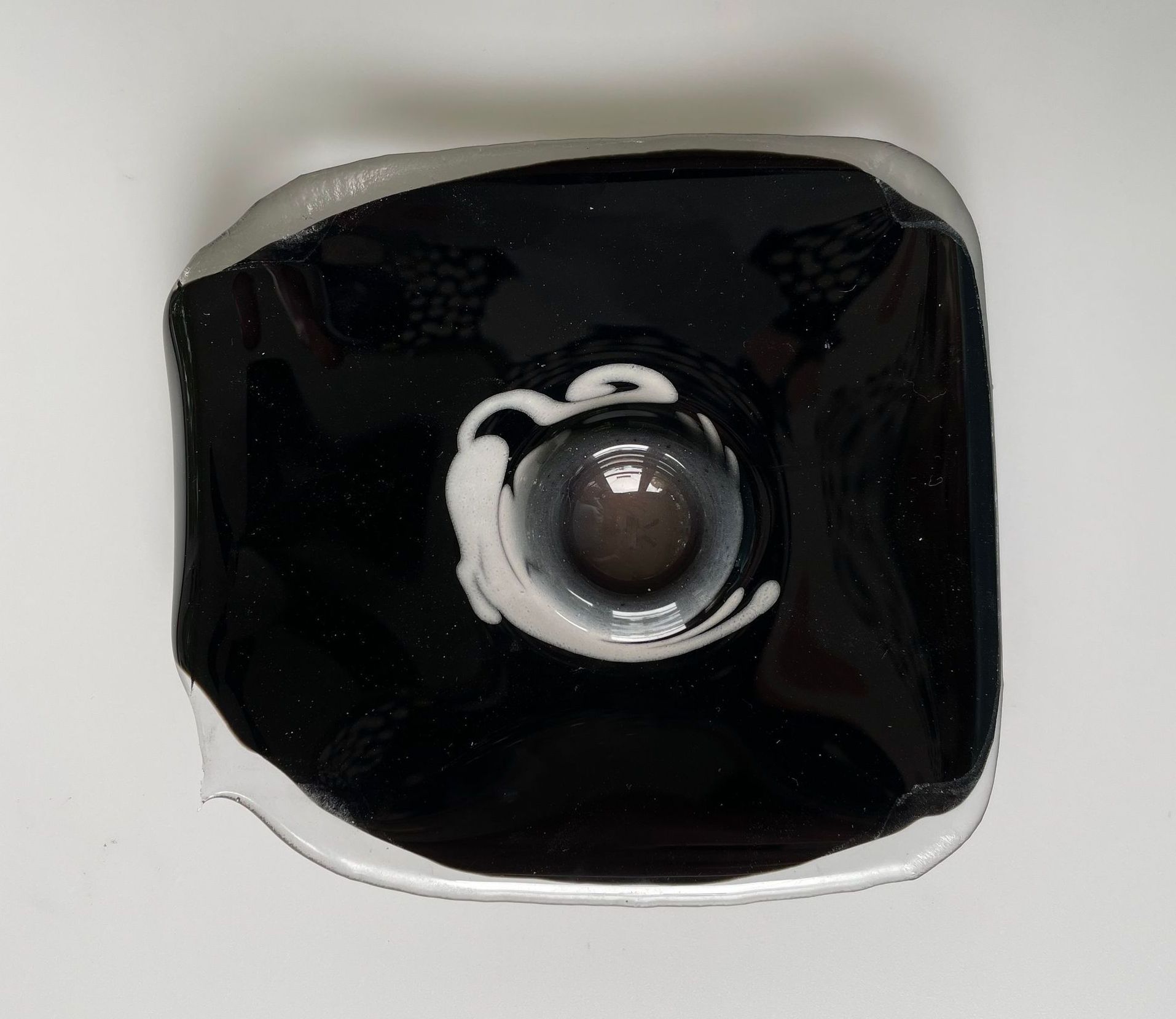 A black and white object with a hole in the middle