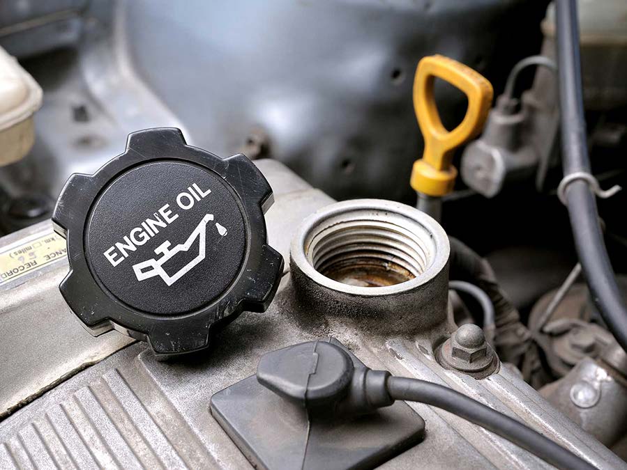 A close up of an engine oil cap on a car