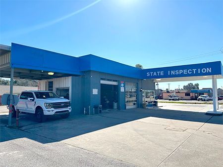 White pickup truck at a blue