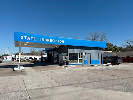 Blue State Inspection building with a sign, exterior view.