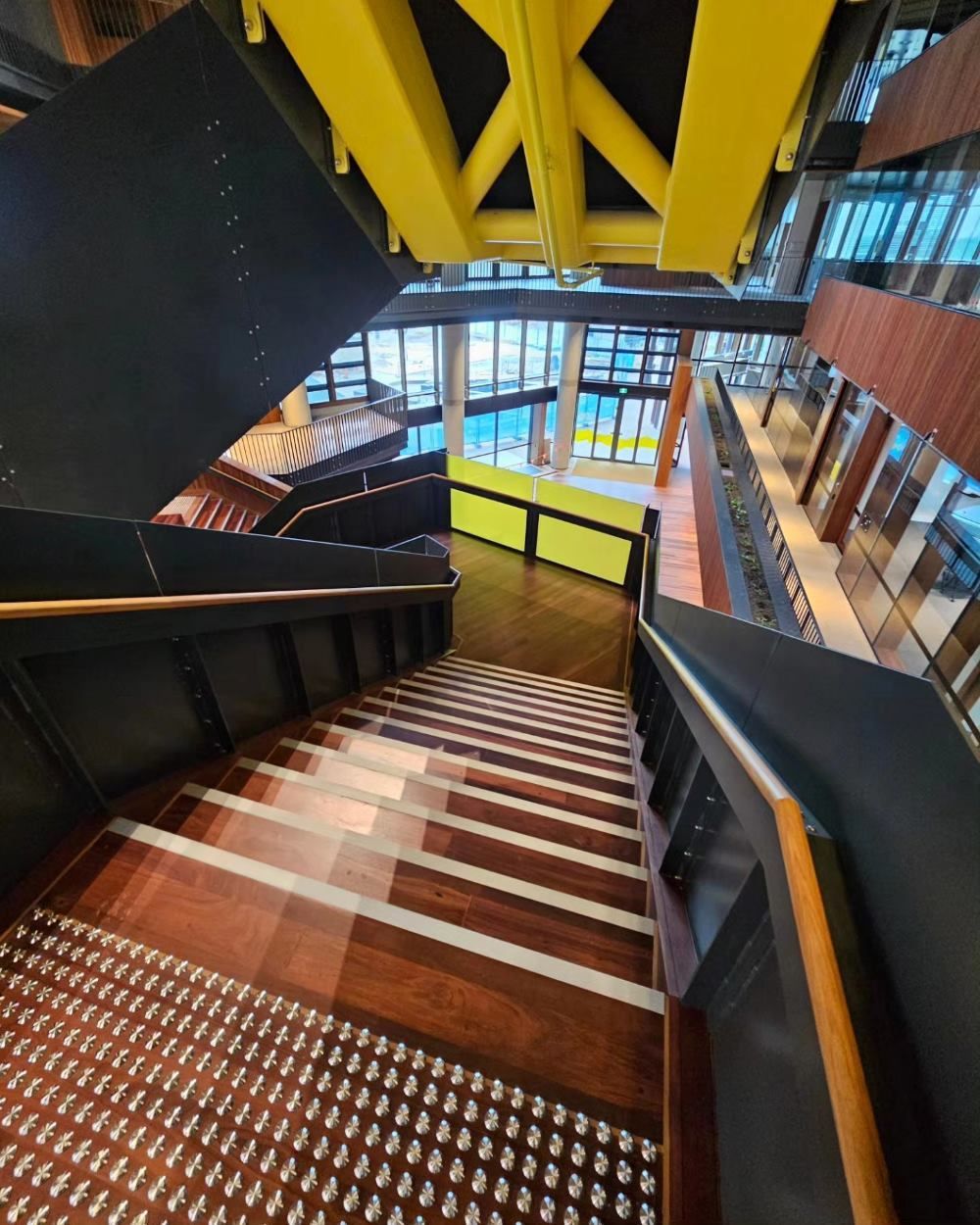 A Large Room With Hardwood Floors and a Ceiling Fan — ATM Floors In Mount Louisa, QLD